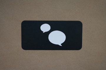 A white speech bubble icon on a black square, symbolising a chatbot conversation