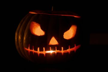 A glowing carved jack-o'-lantern in the dark