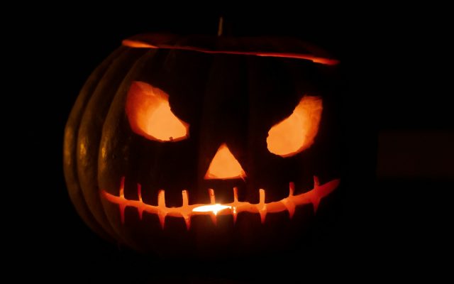 A glowing carved jack-o'-lantern in the dark