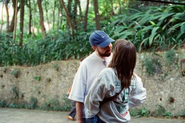 Couple about to kiss in a leafy park