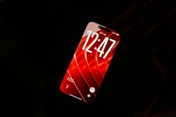 A smartphone with a red screen showing the time, suggesting a subscription renewal reminder